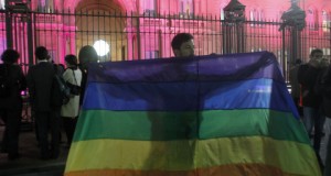 A demonstrator waves a gay pride flag in front of the government palace in Buenos Aires