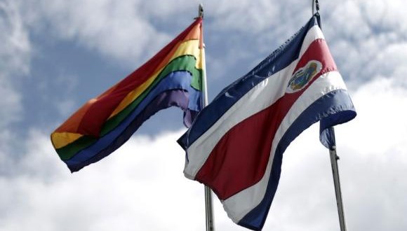 Rainbow flag, which symbolises sexual diversity, is seen after being raised by Costa Rica's President Guillermo Solis, next to Costa Rica's national flag at presidential house in San Jose