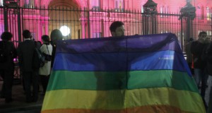 A demonstrator waves a gay pride flag in front of the government palace in Buenos Aires
